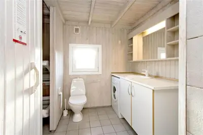 a small bathroom with a toilet and a sink at BL406-Saltum-Graabakken-57 in Saltum