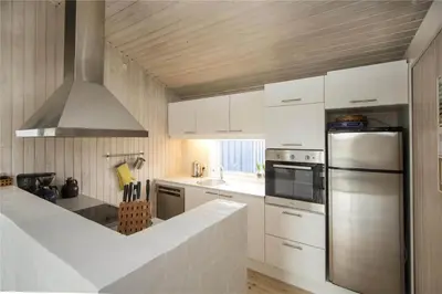 a kitchen with white cabinets and a stainless steel refrigerator at BL406-Saltum-Graabakken-57 in Saltum