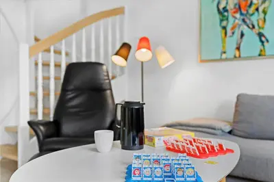 a living room with a table and a chair at BL518-Blokhus-Ferren-Syd-86 in Blokhus