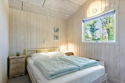 a bedroom with a large bed with a window at BL609-Pandrup-Rodhus-Skolevej-10 in Pandrup