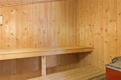 a wooden sauna with a wooden shelf on the wall at BL609-Pandrup-Rodhus-Skolevej-10 in Pandrup