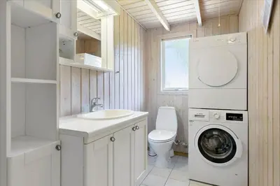 a bathroom with a washing machine and a sink at BL609-Pandrup-Rodhus-Skolevej-10 in Pandrup