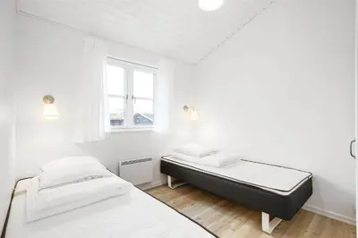 two beds in a white room with a window at BL386-Saltum-Nordvestvej-13 in Saltum