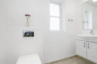 a white bathroom with a toilet and a sink at BL386-Saltum-Nordvestvej-13 in Saltum