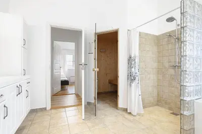 a bathroom with a walk in shower and a glass shower stall at BL386-Saltum-Nordvestvej-13 in Saltum