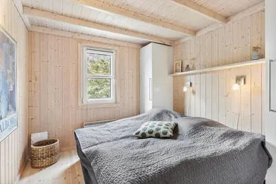 a bedroom with a bed with a pillow on it at BL1227-Saltum-Porsevej-31 in Saltum