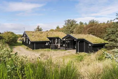 a house with a grass roof on top of a field at BL1227-Saltum-Porsevej-31 in Saltum