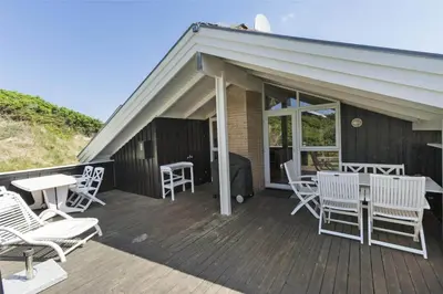 a deck with white chairs and tables and a roof at BL201-Saltum-Kalundborgvej-21 in Saltum