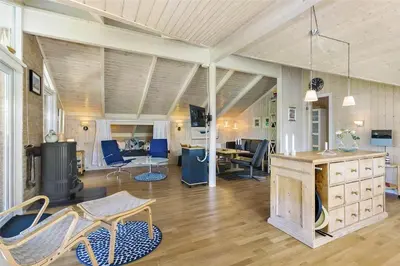 a large living room with blue chairs and a table at BL201-Saltum-Kalundborgvej-21 in Saltum