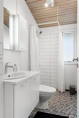a white bathroom with a toilet and a sink at BL103-Saltum-Daadyrvej-23-A in Saltum