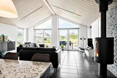 a living room with a couch and a fireplace at BL417-Blokhus-Saetergaardsstien-6-A in Blokhus
