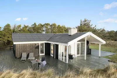 a small house with a deck and a roof at BL1770-Saltum-Klittornvej-5 in Saltum