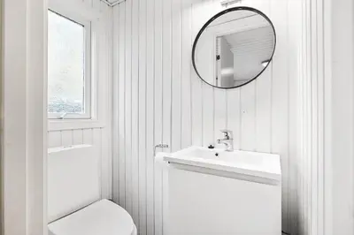 a bathroom with a sink and a toilet and a mirror at BL1770-Saltum-Klittornvej-5 in Saltum