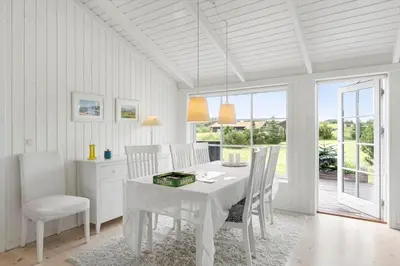 a white dining room with a white table and chairs at BL653-Saltum-Nordvestvej-27 in Saltum