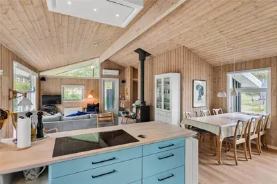 a kitchen and living room with a table and a couch at BL1627-Blokhus-Lyngvej-17 in Blokhus