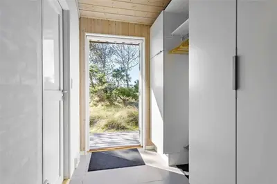 a hallway with an open door and a window at BL809-Pandrup-Lommelaerken-20 in Pandrup