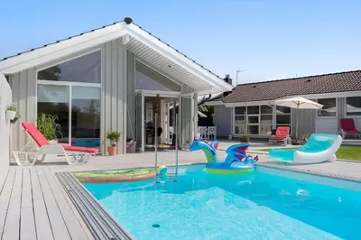 a swimming pool with colorful inflatables in a house at BL1477-Blokhus-Park-Alle-5 in Blokhus