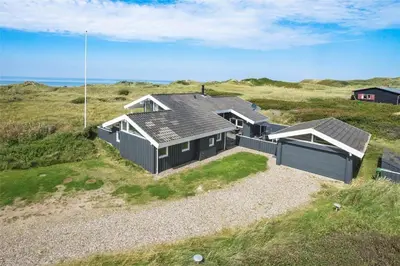 an aerial view of a house on the beach at BL1555-Blokhus-Egebaeksvej-17 in Blokhus