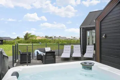 a hot tub on the deck of a house at BL234-Blokhus-Sdr-Strandvej-9-A in Blokhus