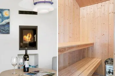 a room with a fireplace and a table with wine glasses at BL1660-Saltum-Hvide-Klit-7 in Saltum