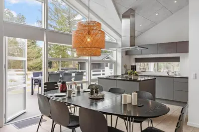 a kitchen and dining room with a table and chairs at BL1367-Blokhus-Saetergaardsstien-12 in Blokhus