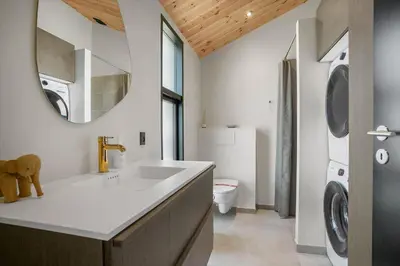 a bathroom with a sink and a washing machine at BL1436-Blokhus-Mollevej-13 in Blokhus