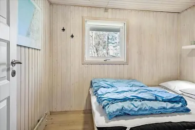 a small room with a bed and a window at BL1361-Saltum-Jaerens-Rev-Sydvest-8 in Saltum