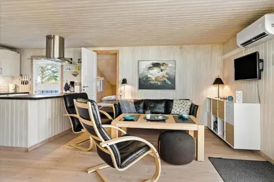 a kitchen and living room with a table and chairs at BL1361-Saltum-Jaerens-Rev-Sydvest-8 in Saltum