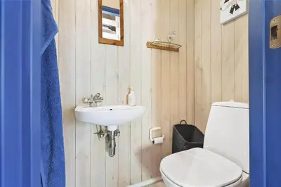 a bathroom with a toilet and a sink at BL1186-Blokhus-Morten-Nielsensvej-84 in Blokhus