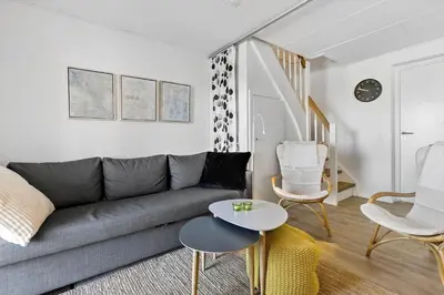 a living room with a couch and a table at BL1584-Blokhus-Strandvejen-14-Lejl-4 in Blokhus