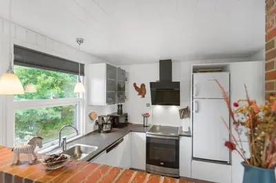 a kitchen with white cabinets and a white refrigerator at BL1487-Saltum-Brune-Banke-7 in Saltum