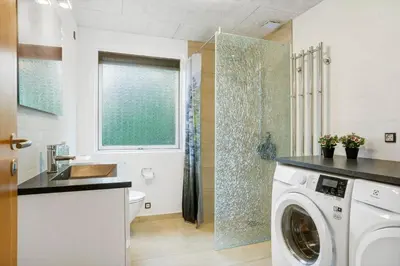 a bathroom with a washing machine and a shower at BL1487-Saltum-Brune-Banke-7 in Saltum