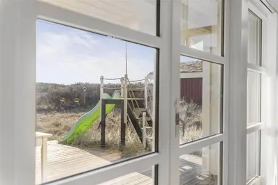 a window view of a playground seen through a window at BL1455-Blokhus-Pirupshvarrekrogen-6 in Blokhus