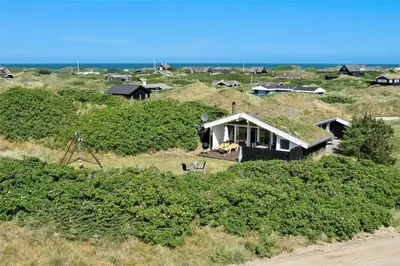 a house on a hill with the ocean in the background at BL317-Saltum-Kalundborgvej-1 in Saltum