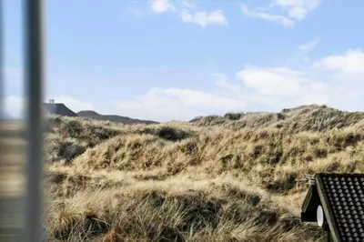 a grassy hill with a house on top of it at BL1530-Saltum-Kohlsvej-7 in Saltum