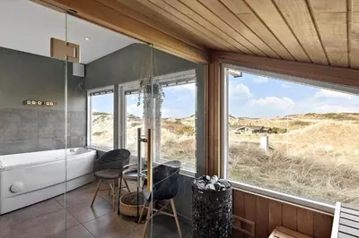 a bathroom with a tub and a large window at BL1530-Saltum-Kohlsvej-7 in Saltum