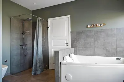 a bathroom with a tub and a shower and a toilet at BL1530-Saltum-Kohlsvej-7 in Saltum