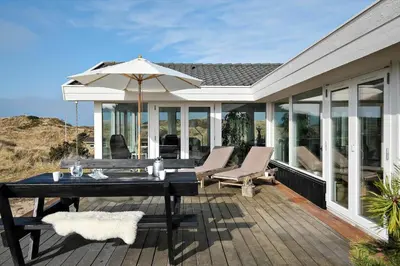 a patio with a table and chairs and an umbrella at BL1530-Saltum-Kohlsvej-7 in Saltum