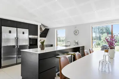 a kitchen with a white counter top and a table at BL1491-Saltum-Laustvej-10 in Saltum