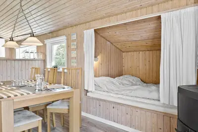 a room with a bed in a wooden wall at BL286-Blokhus-Bag-Hojen-31 in Blokhus