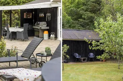 a patio with a grill and a table and chairs at BL1247-Blokhus-Skraavejen-24 in Blokhus