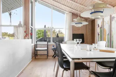 a dining room with a white table and chairs at BL177-Saltum-Kvansletten-23 in Saltum