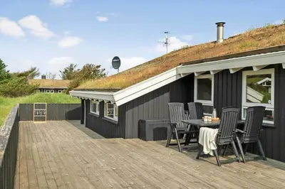 a deck with chairs and a table on a house at BL177-Saltum-Kvansletten-23 in Saltum
