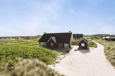 a house on the beach with a road at BL1357-Blokhus-Ved-Stranden-2 in Blokhus