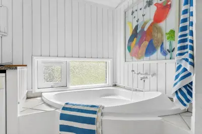 a white bathroom with a tub and a window at BL832-Saltum-Kohlsvej-8 in Saltum