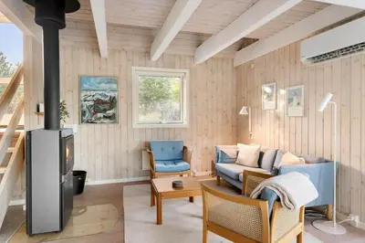 a living room with a couch and a fireplace at BL1362-Saltum-Kronhjortvej-19 in Saltum