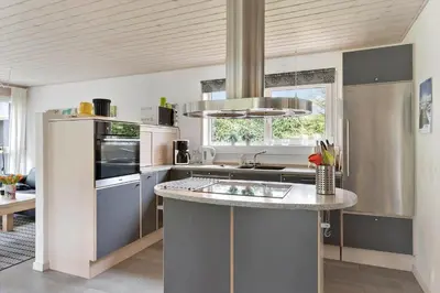 a kitchen with stainless steel appliances and a sink at BL381-Blokhus-Maxvej-4 in Blokhus