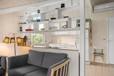 a living room with a couch and a kitchen at BL1558-Saltum-Opossumvej-20 in Saltum