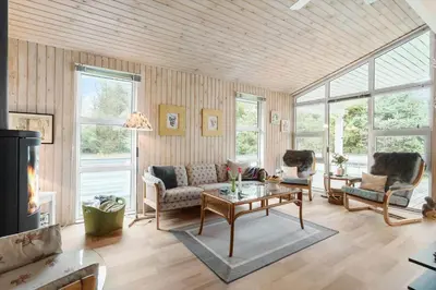 a living room with a couch and a table at BL1213-Pandrup-Rodhusparken-14 in Pandrup