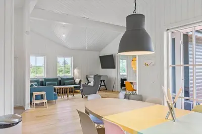 a living room with a table and a dining room at BL1559-Saltum-Nordvestvej-25 in Saltum